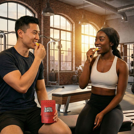 Two people in a gym eating snacks from a bag labeled 'Buzzy Snacks'.